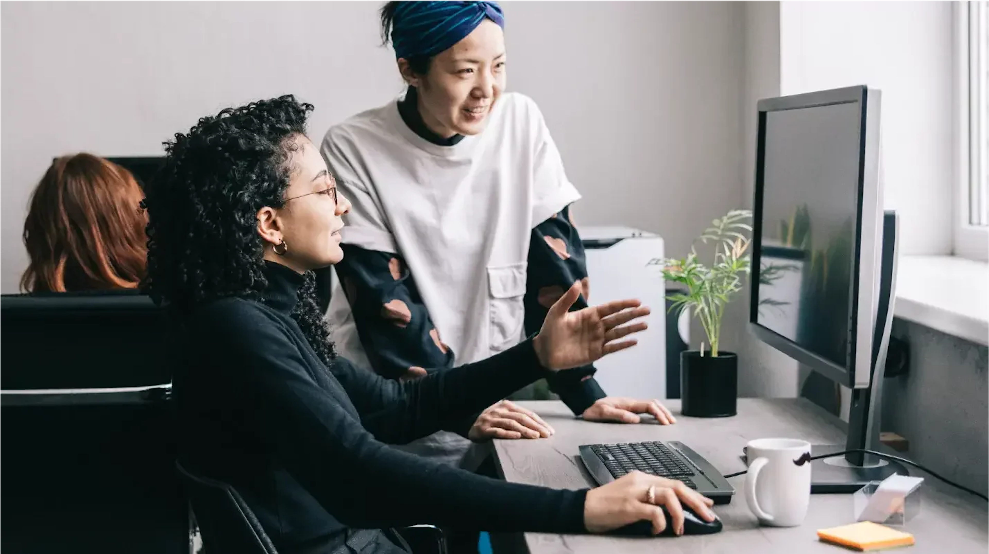 Photo of two team members working with tech